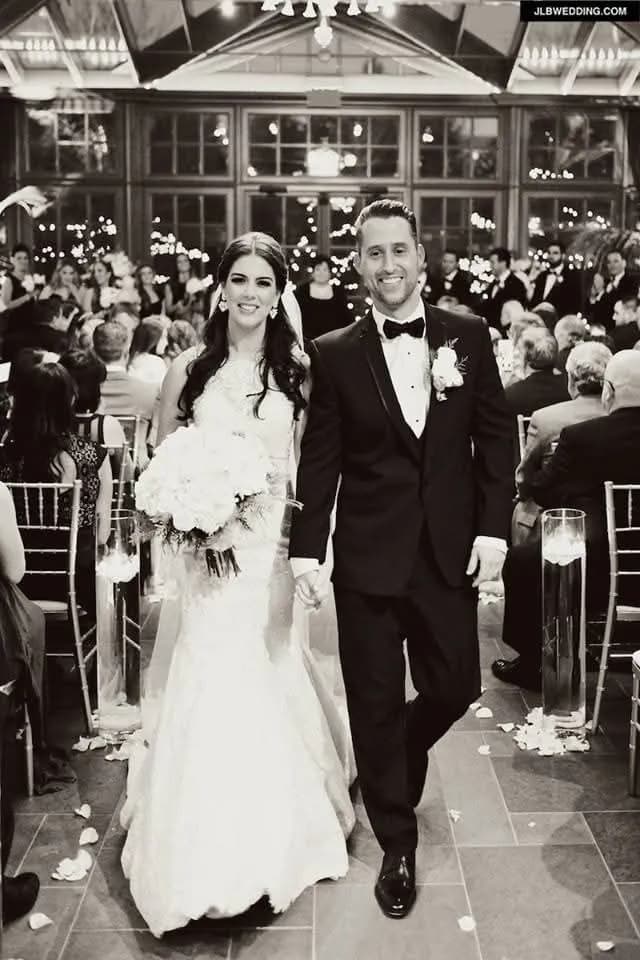 Couple walking down the aisle with confetti